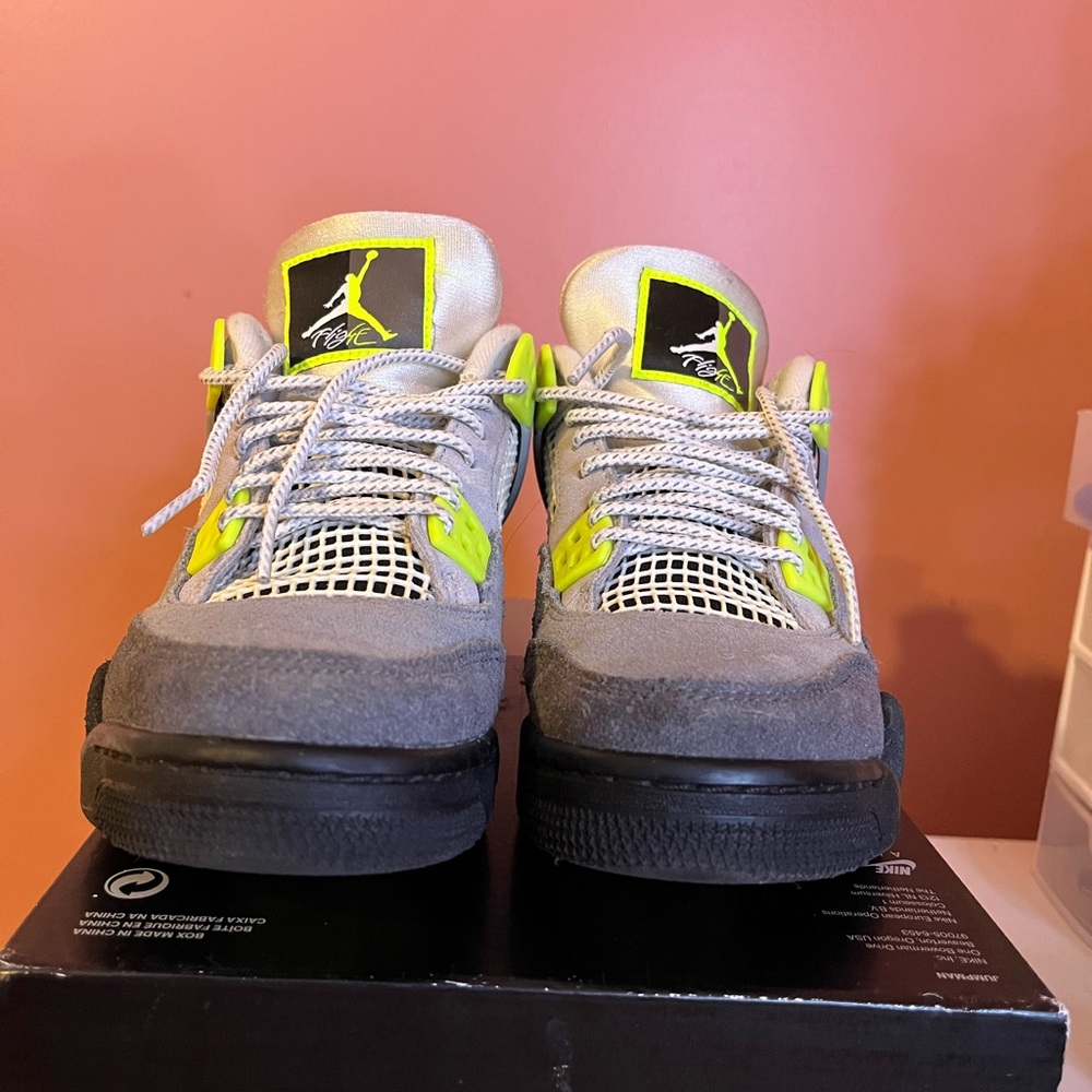 Nike Jordan 4s black grey and neon green sneakers.
